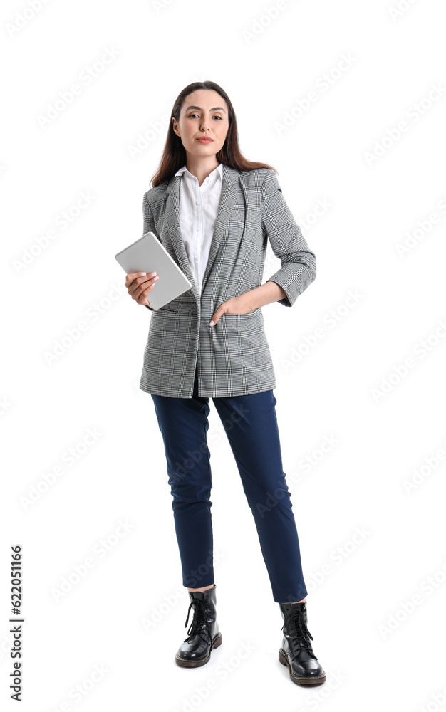 Young woman in stylish suit with tablet computer on white background