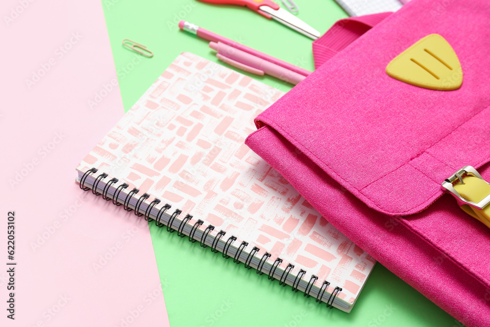 School backpack, notebook and stationery on color background, closeup