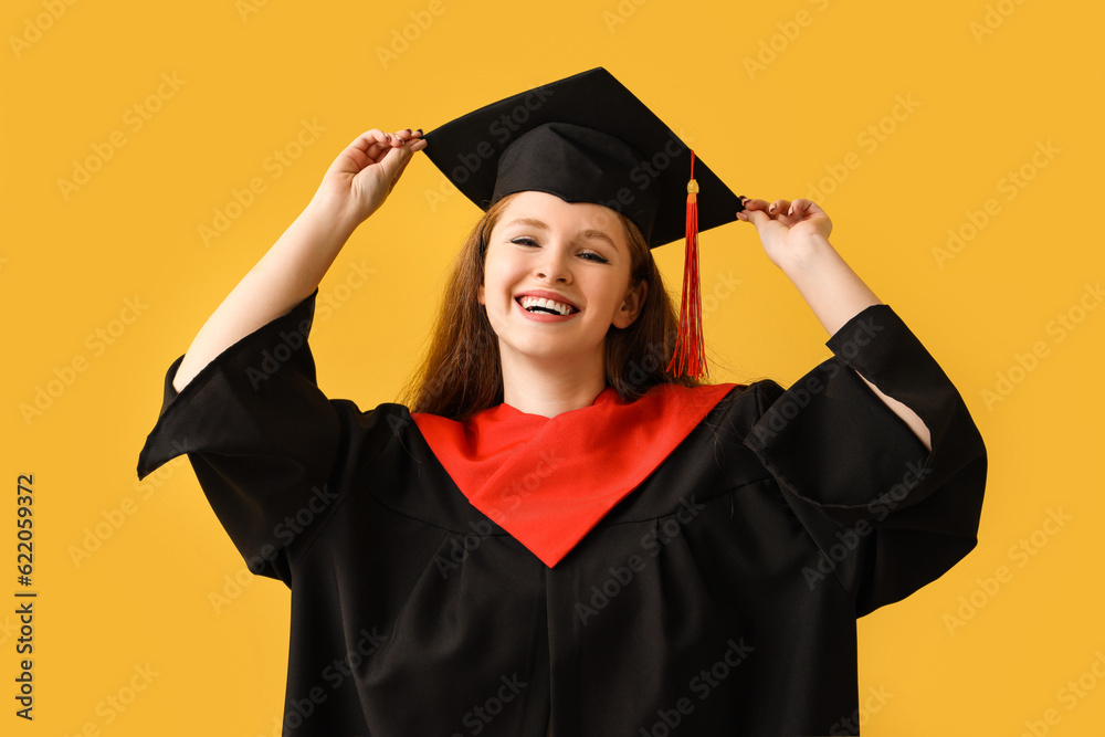 Female graduate student on yellow background