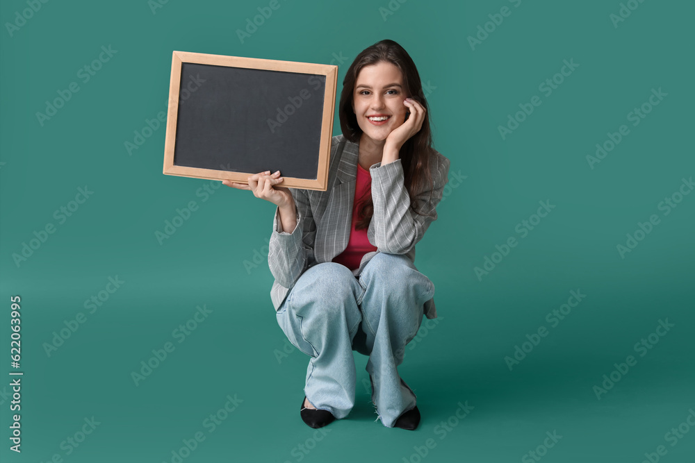 Female teacher with chalkboard on green background