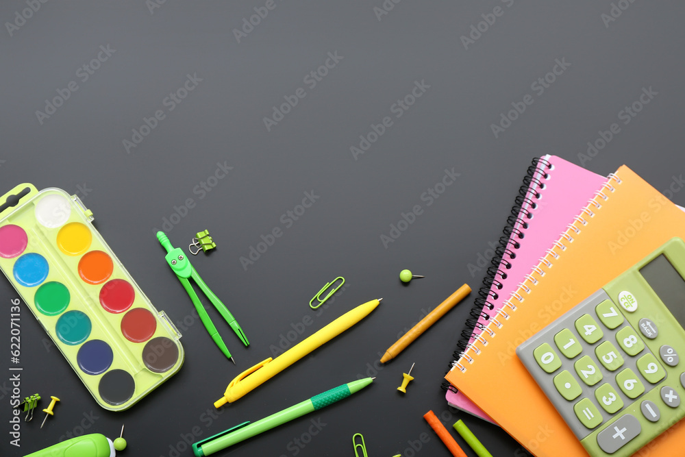 Calculator with different stationery on black chalkboard