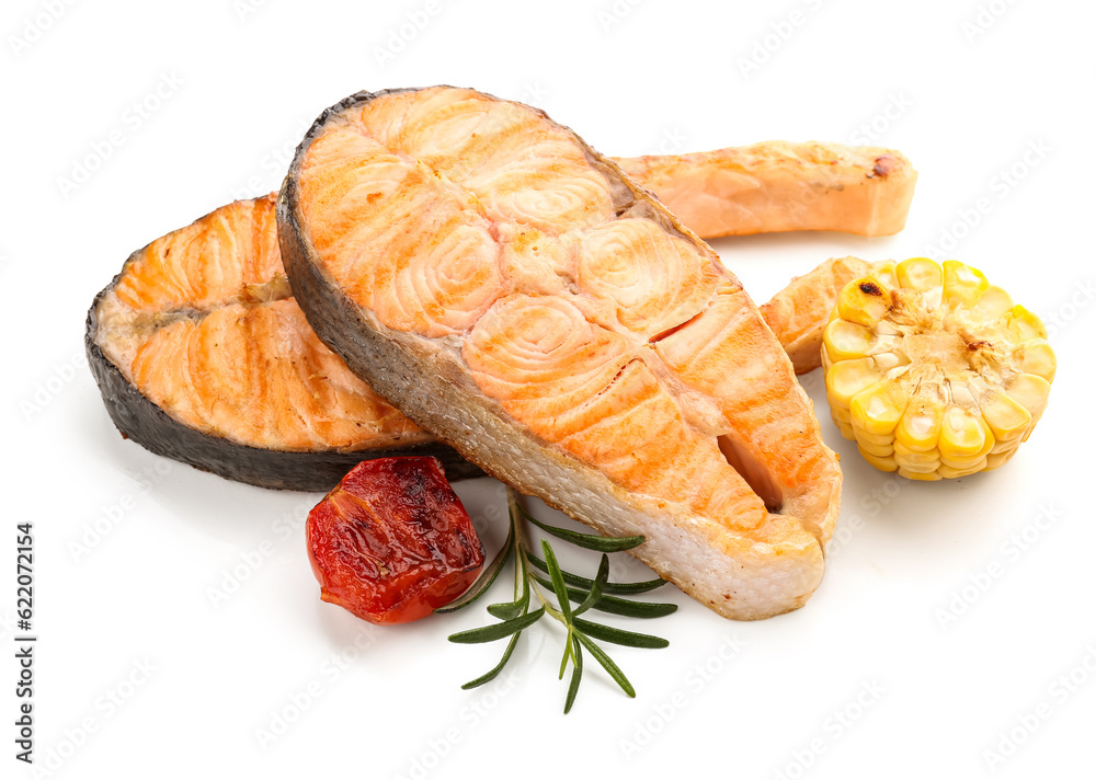 Tasty grilled salmon steaks and vegetables on white background