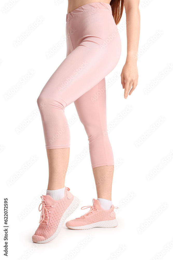 Sporty young woman in leggings on  white background