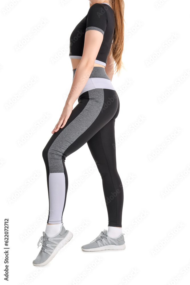 Young woman in sportswear on white background