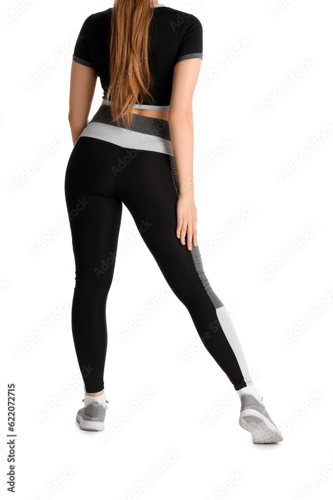 Young woman in sportswear on white background, back view