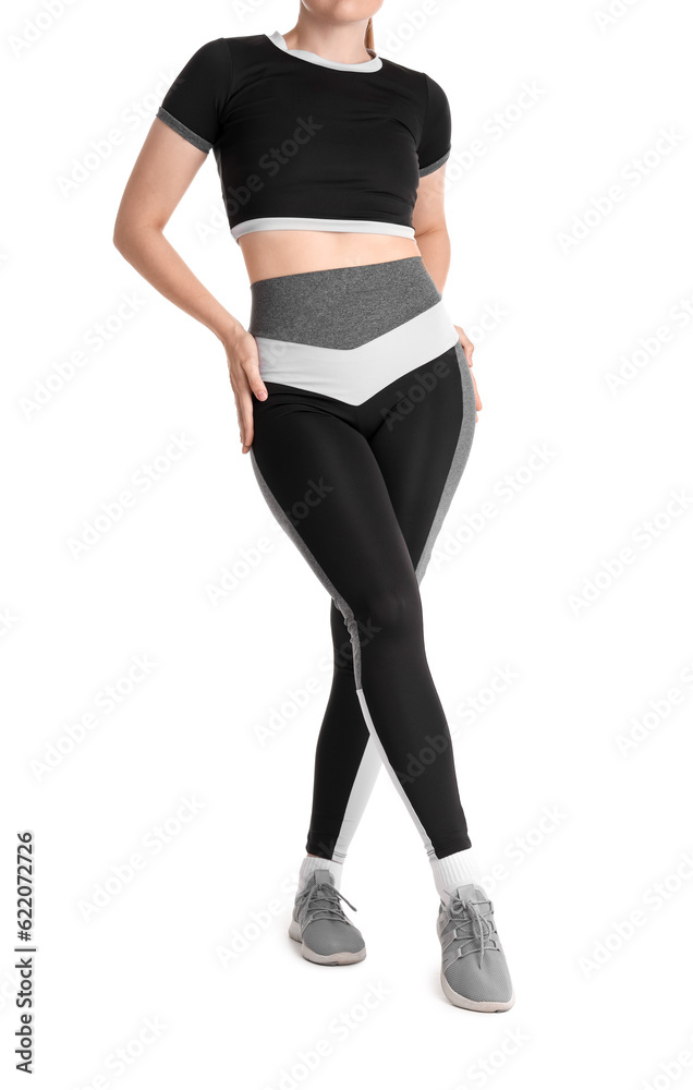 Young woman in sportswear on white background