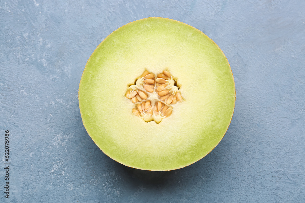 Half of sweet melon on blue background