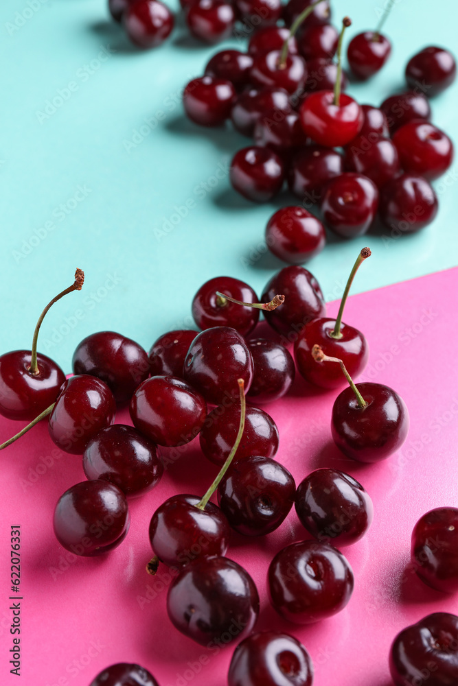 Many sweet cherries on colorful background