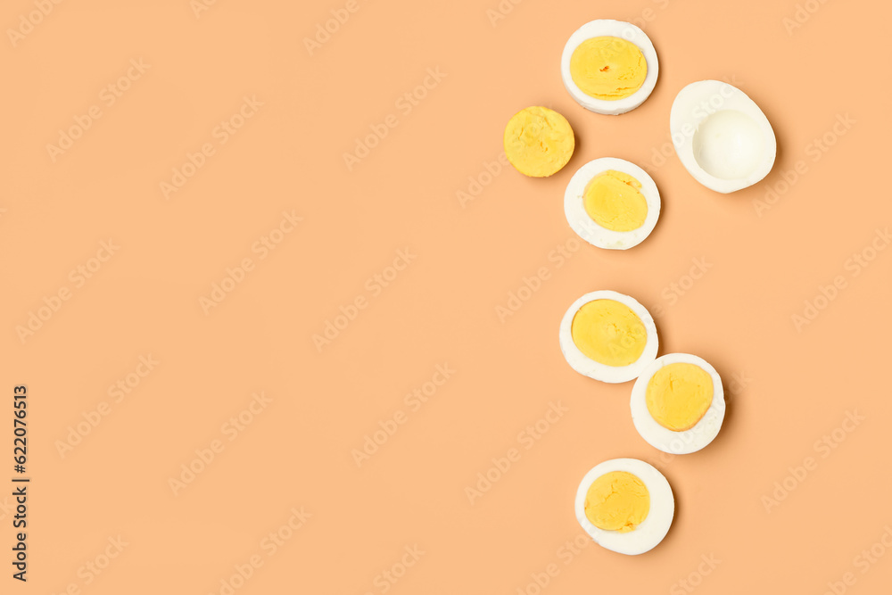 Slices of tasty boiled eggs on orange background