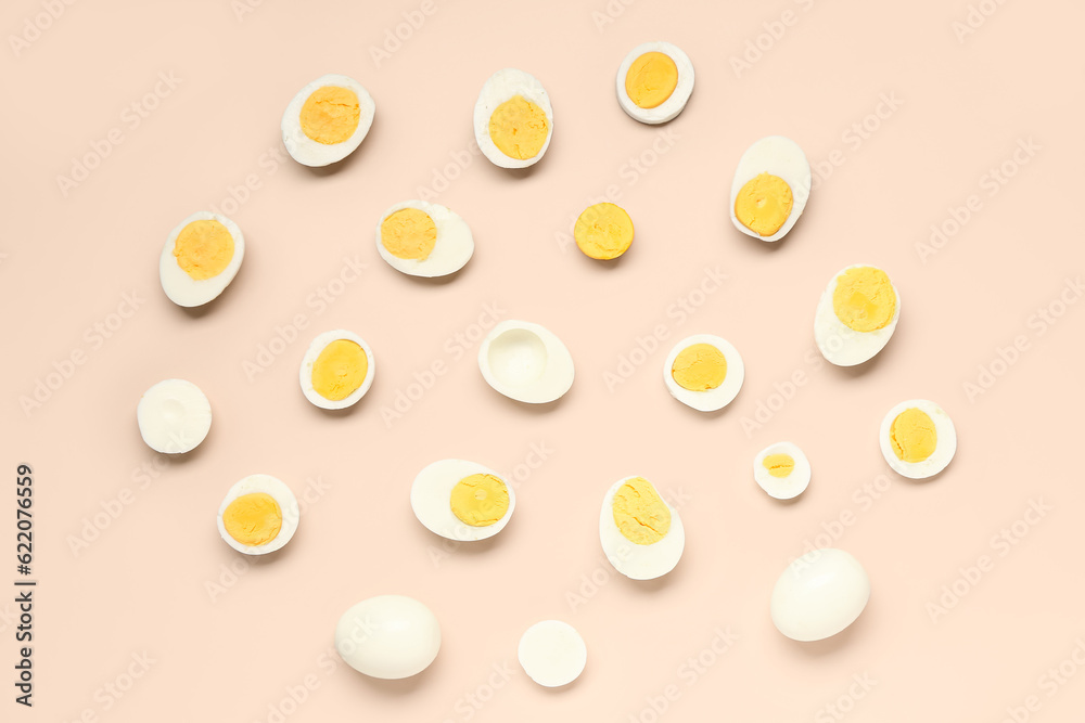 Tasty boiled eggs with halves on pink background