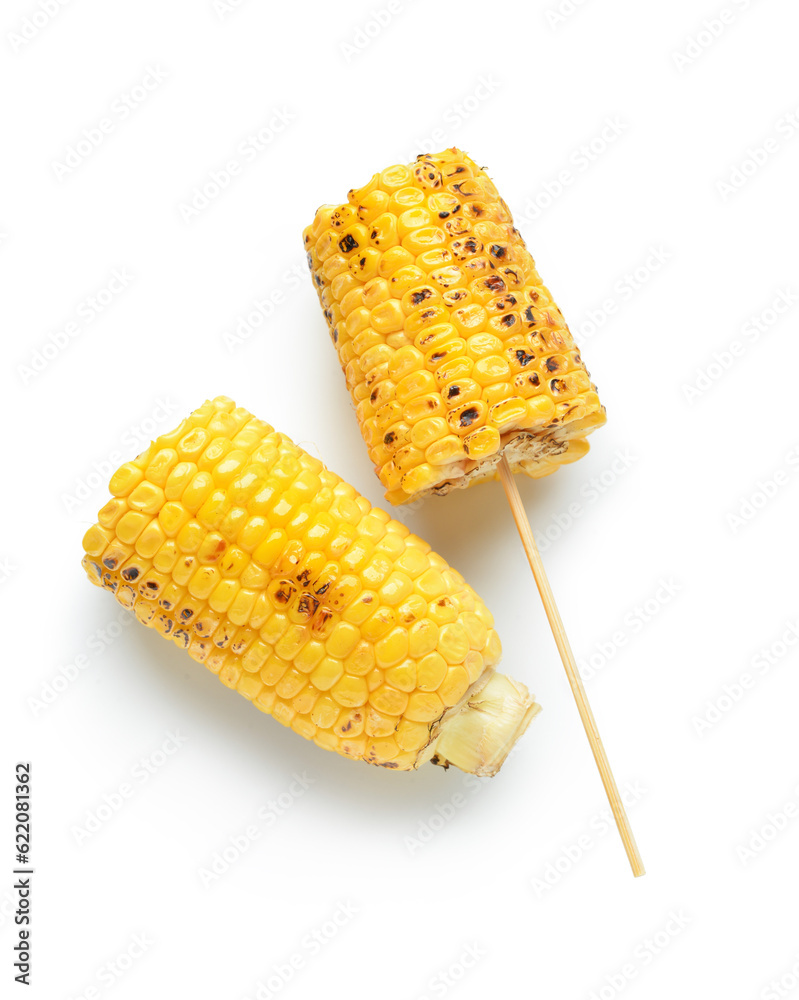 Tasty grilled corn cob skewers on white background