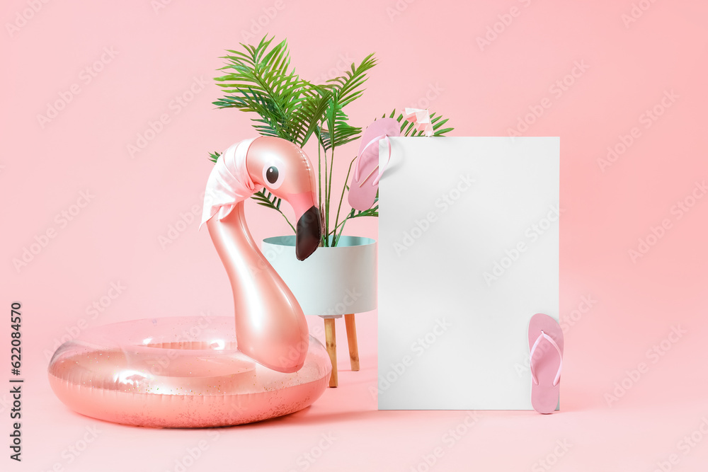 Blank poster with inflatable ring in shape of flamingo and plant leaves on pink background. Travel c