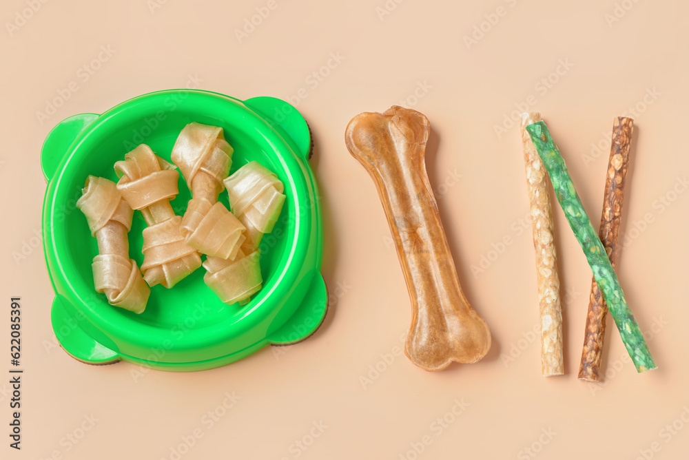 Set of different dog treats on color background