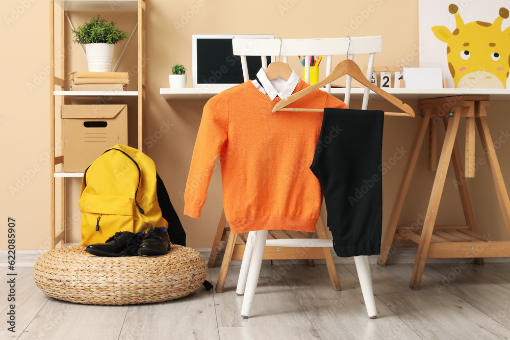 Stylish interior of childrens room with school uniform