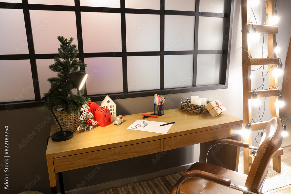 Home office desk with Christmas tree and decorations