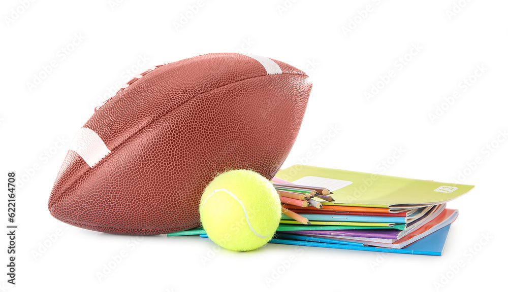 Notebooks with colorful pencils, rugby and tennis balls isolated on white background