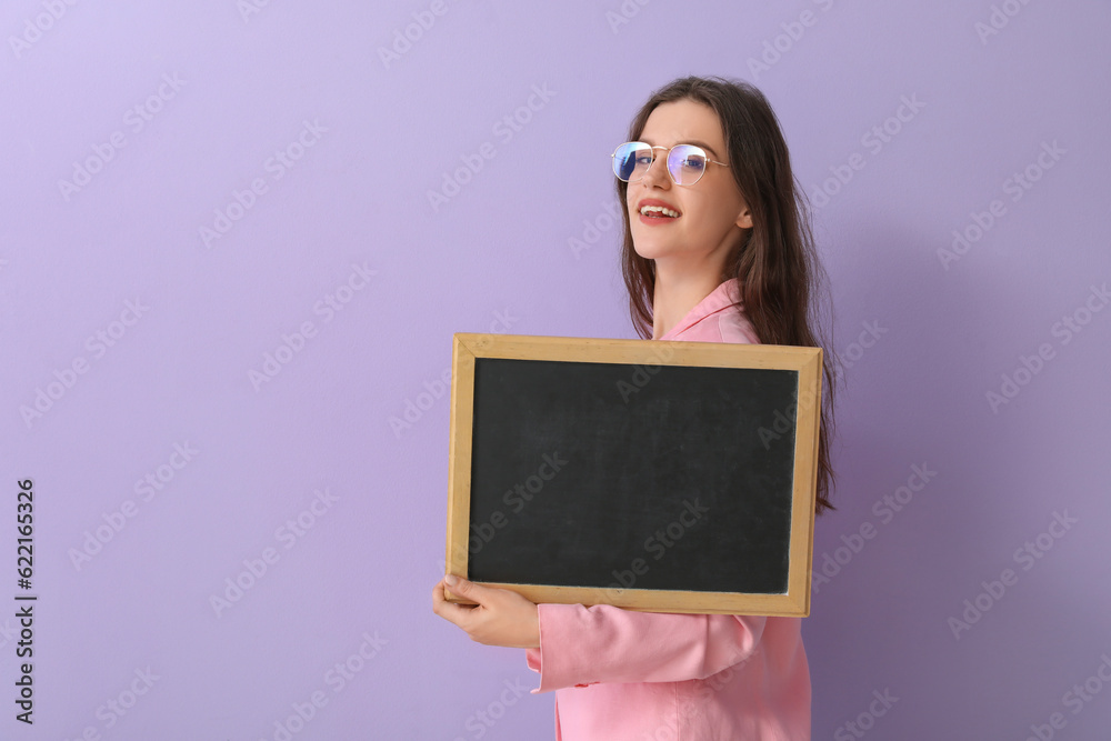 Female teacher with chalkboard on lilac background