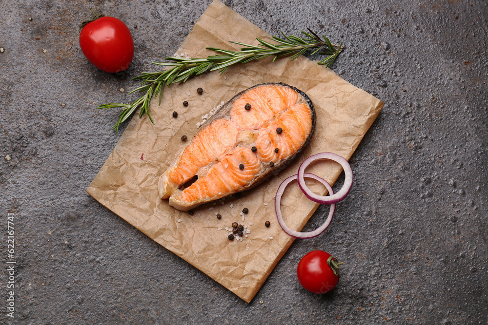 Tasty grilled salmon steak on brown background