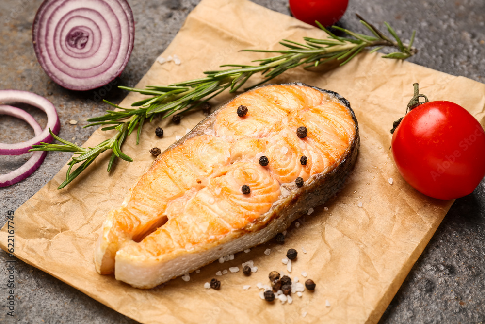 Tasty grilled salmon steak on brown background