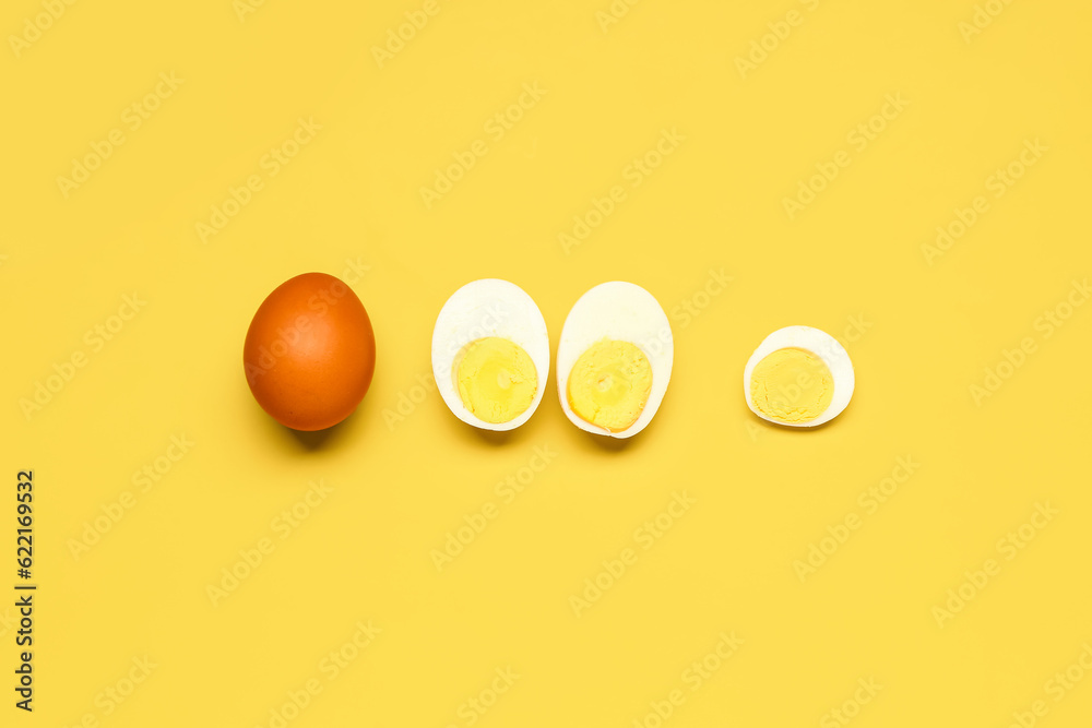 Tasty boiled eggs on yellow background