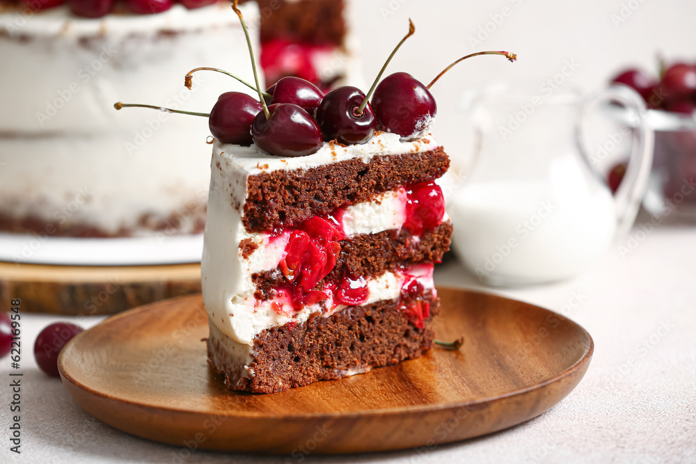 Plate with piece of tasty cherry cake on light background