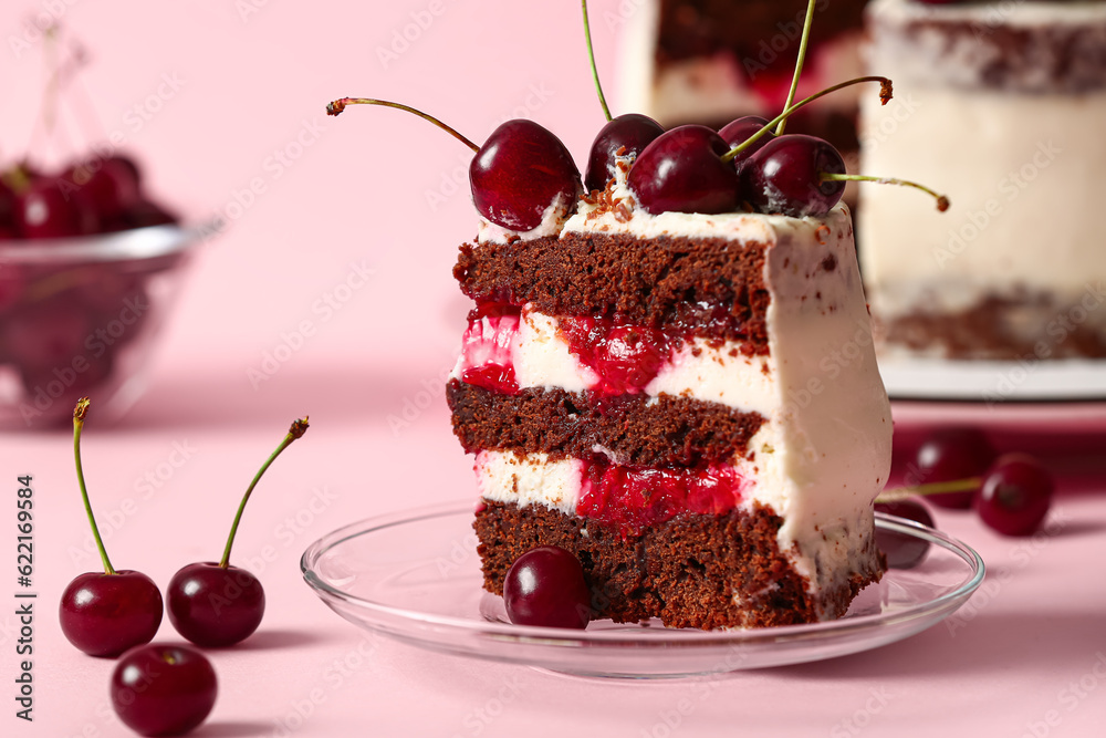 Plate with piece of tasty cherry cake on pink background