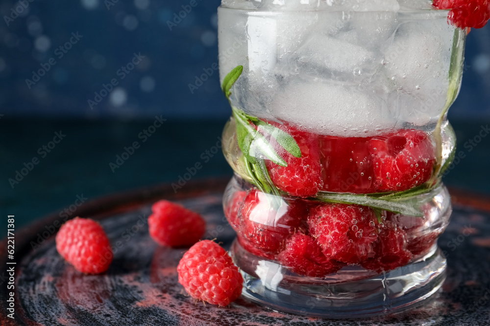 Glass of fresh raspberry lemonade with rosemary on dark table