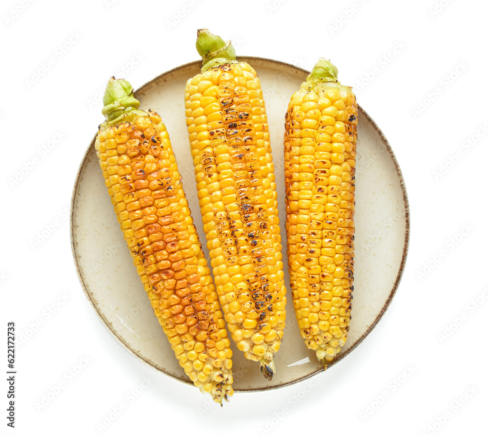 Plate with tasty grilled corn cobs on white background