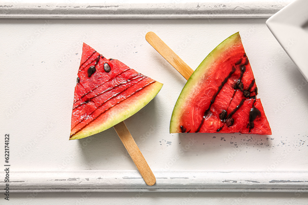 Sweet watermelon sticks on white table