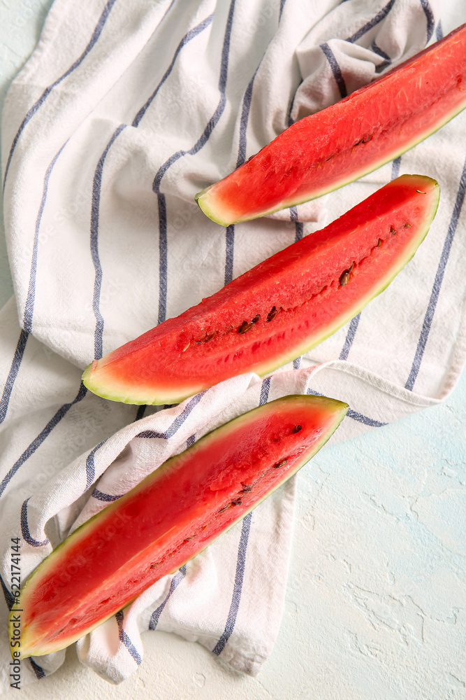 Pieces of fresh watermelon on light blue table