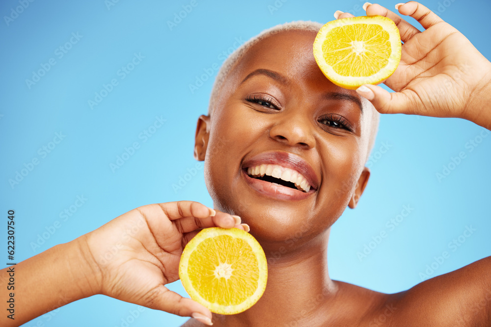 Portrait, orange and beauty with a model black woman in studio on a blue background for nutrition. S