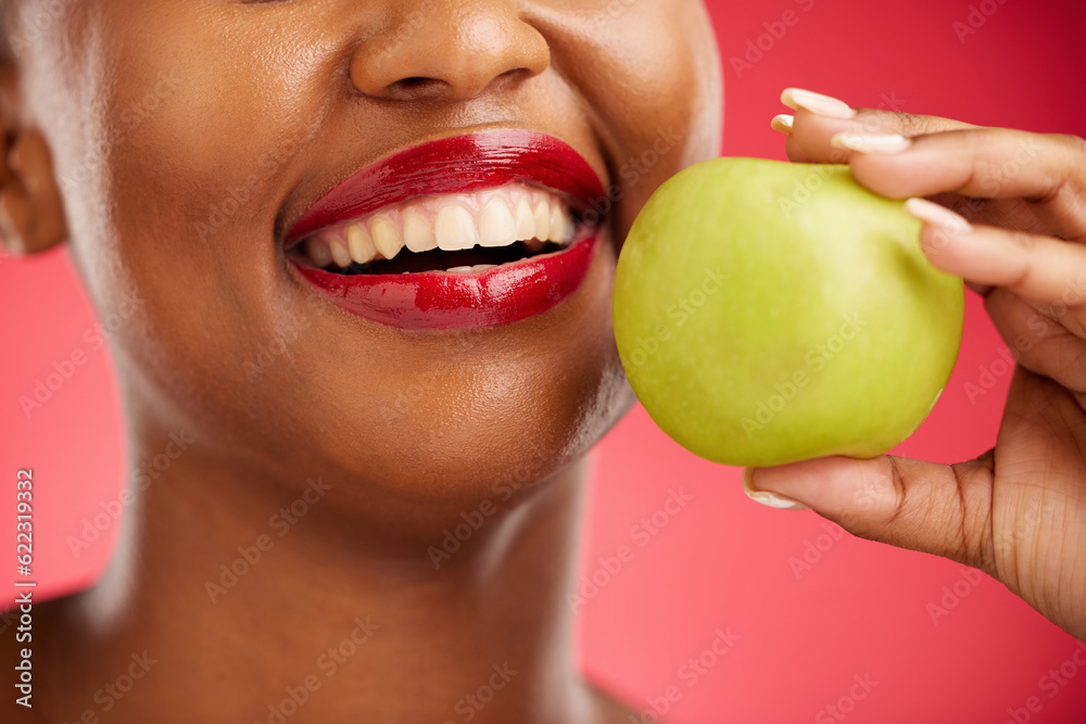 Woman, mouth and apple in diet, nutrition or health and wellness against a red studio background. Cl