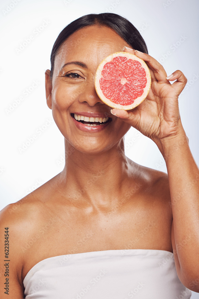 Skincare, face and mature woman with grapefruit in studio isolated on a white background. Portrait, 