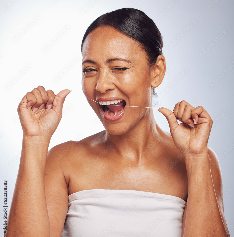 Dental, portrait or mature woman flossing teeth for beauty or wellness in studio on white background