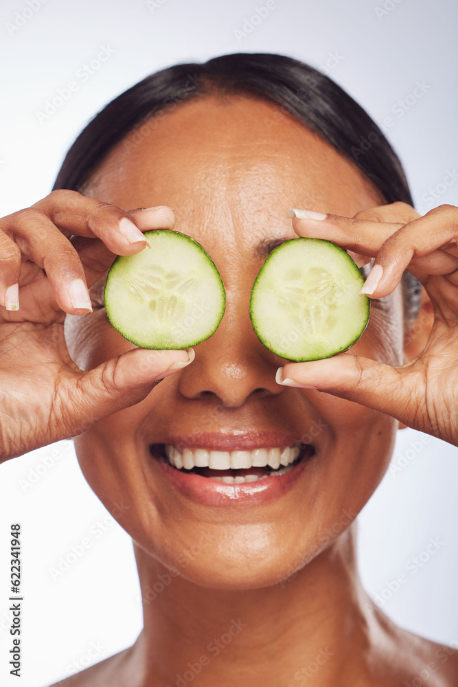 Cucumber, face and skincare of happy woman in studio, white background and aesthetic shine. Female m