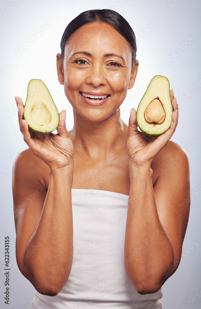 Portrait, skincare and senior woman with avocado in studio isolated on a white background. Face, nat