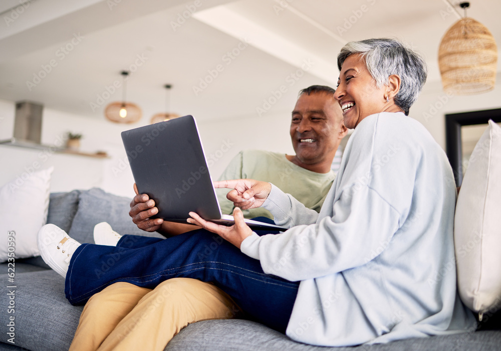 Mature couple, laptop and relax on sofa in living room, download media and choice of watching movie 