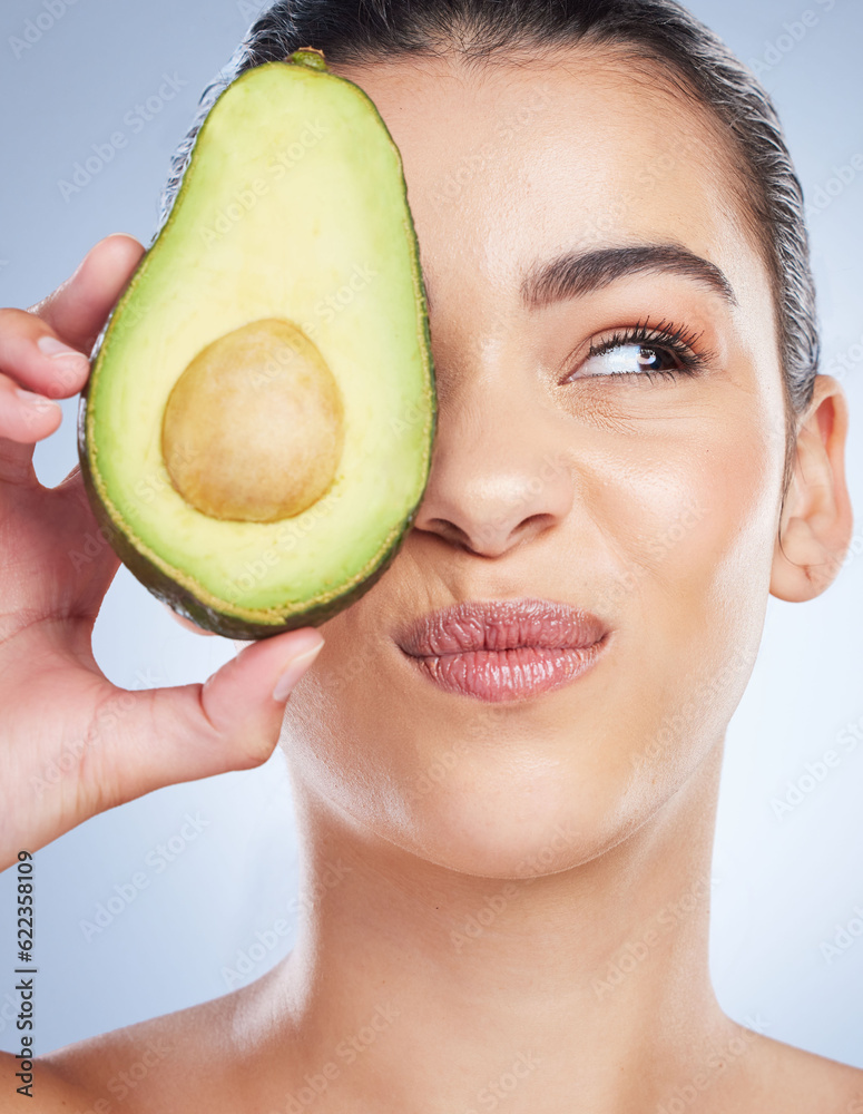 Avocado, skincare and face of woman in studio with doubt of natural detox, wellness or omega 3 treat