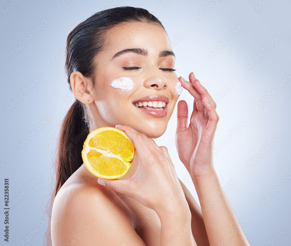 Lemon, skincare and asian woman with face cream in studio for wellness or cosmetic mask on grey back