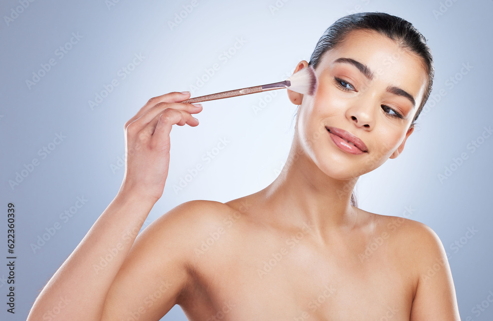 Beauty, cosmetic and woman with a makeup brush in a studio for natural, glamour and face routine. Gl