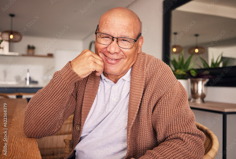 Portrait, smile and glasses with a senior man sitting in the living room of his home during old age 