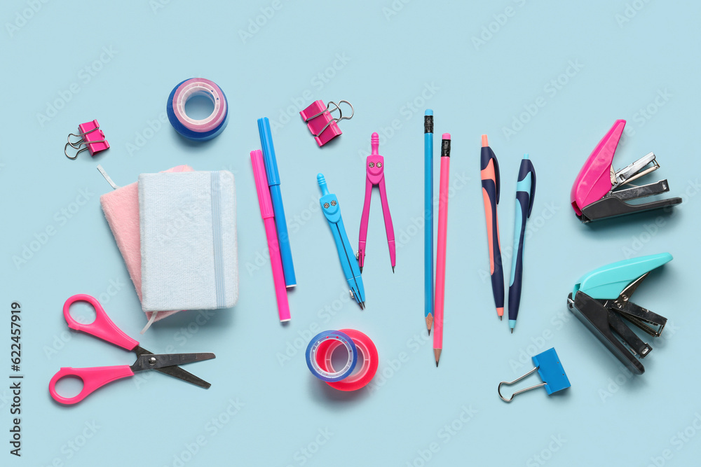 Composition with stationery supplies on blue background