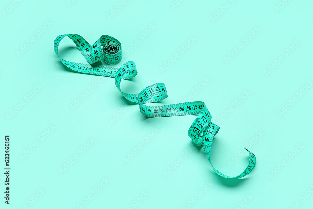 New measuring tape on turquoise background