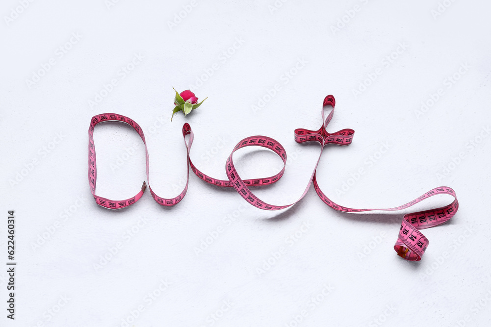 Composition with measuring tape and rose on light background. Diet concept