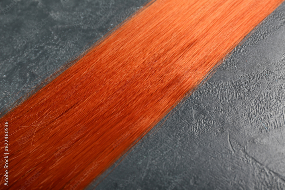 Ginger hair strand on dark background, closeup