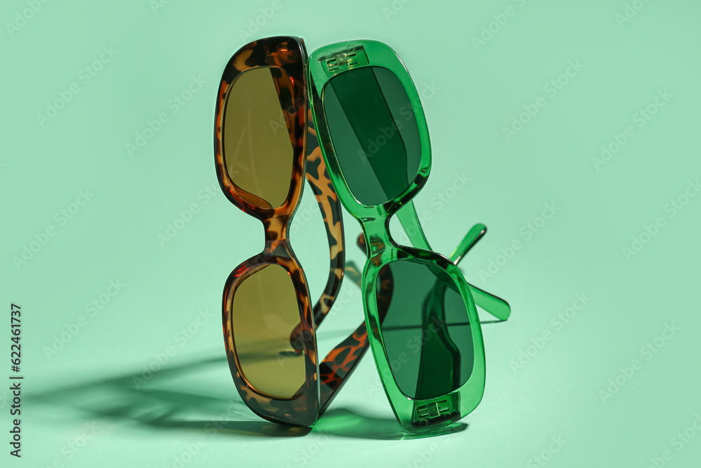 New eyeglasses on green background