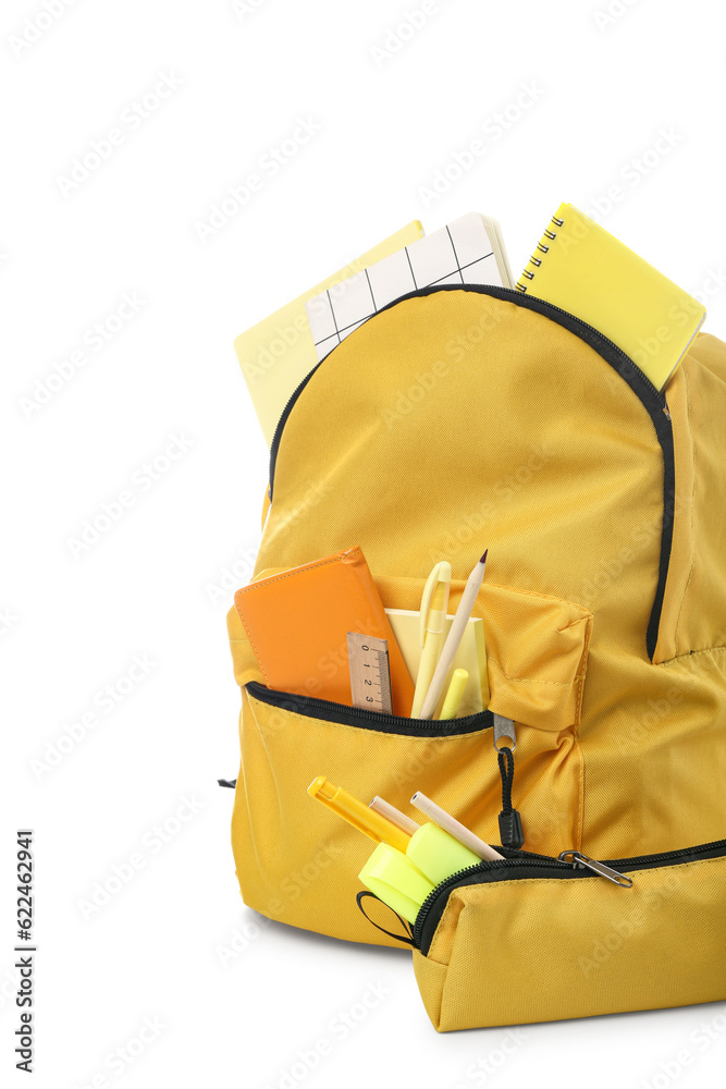 Yellow school backpack with pencil case, notebooks and stationery on white background