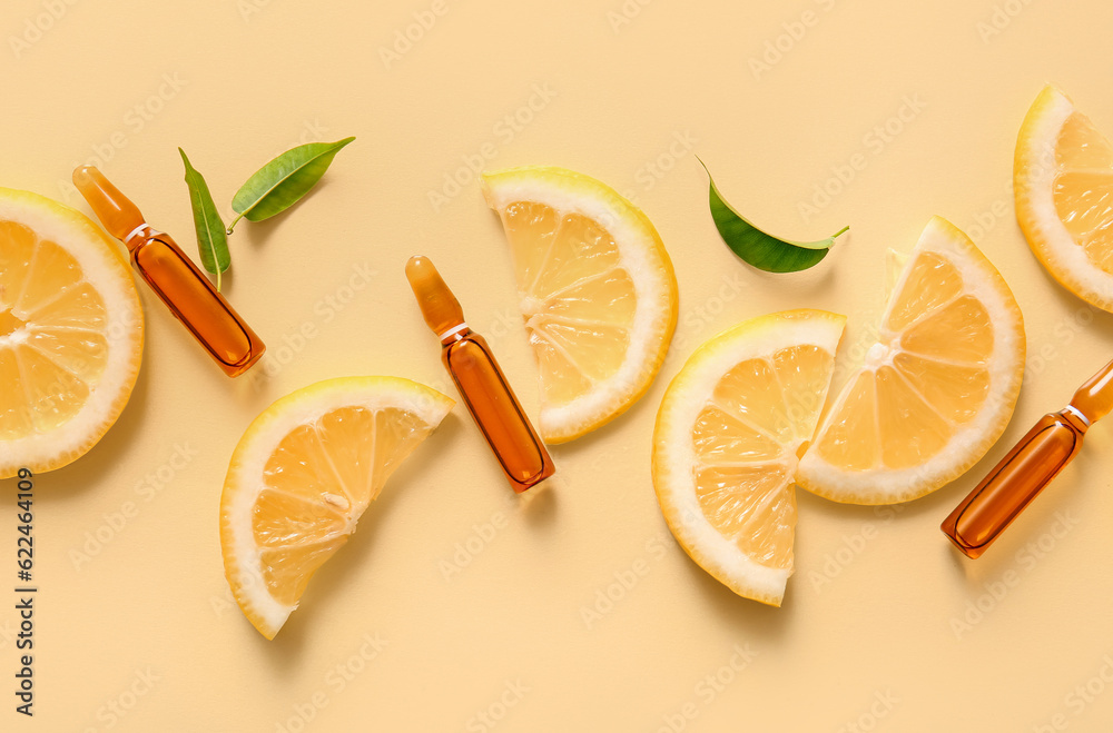 Ampoules with vitamin C and lemon slices on yellow background