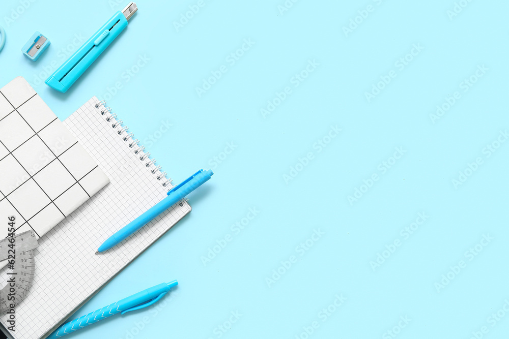 Notebooks and stationery on blue background