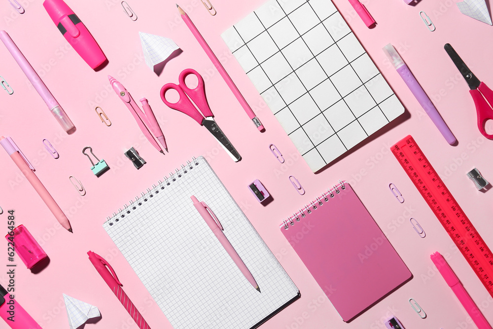 Set of different school stationery on pink background